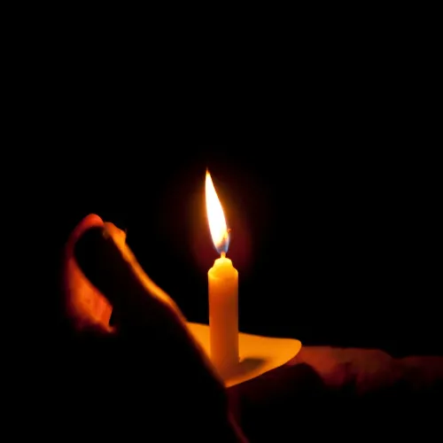 A candle lit in remembrance of lives lost