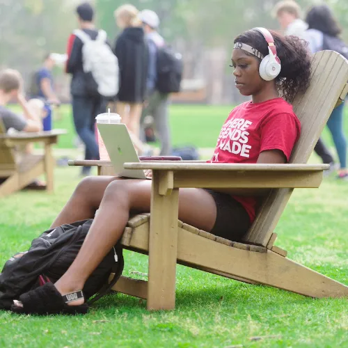 A student studying on the quad